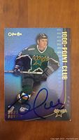 Front of autographed Brett Hull 1996-97 OPC Choice hockey card showing player in Dallas Stars uniform with blue autograph.