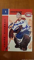 Front of the Charlie Hodge Montreal Canadiens goaltender hockey card with autograph in blue ink.