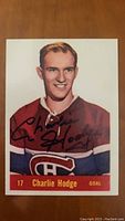 Front view of vintage Charlie Hodge hockey card signed by Charlie Hodge, showing him in a Montreal Canadiens red uniform with number 17 and labeled GOAL.