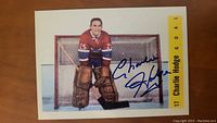 Signed Charlie Hodge hockey card in goalie gear with autograph