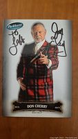 Front of autographed Don Cherry trading card in red plaid jacket