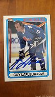 Front of signed hockey card showing Guy Lafleur in Quebec Nordiques uniform with autograph in blue ink