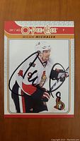 Front of signed Milan Michalek O-Pee-Chee hockey card featuring player in Ottawa Senators jersey.