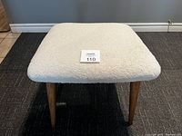 Top view showing the thickly padded seat covered in white wooly chenille upholstery fabric.