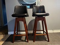 Front view of both stools showing seat and base design