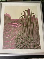 Frontal photo of framed painting showing full artwork with stylized rush plants, water, and landscape in pink and green tones.