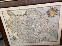 Full view of the framed historical map of Yorkshire with surrounding wood frame and glass, showing map coloration and text.