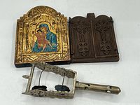Overview photo of all three items: painted icon, carved wooden panel, and metal incense holder.
