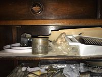 Photo showing assorted kitchen tools including handheld grater, metal food ricer, pastry molds, and cookie cutters