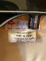 Close-up of clothing label showing brand 'Befona', 100% silk, made in China, silk blouse.