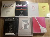 Top view of eight erotic art and sexuality-related books showing titles and cover designs.