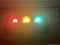 Lamp powered on with red, yellow, and green lights illuminated brightly.