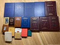 Photo showing a spread of Jewish books including blue hardcover books, brown and dark hardcovers, and smaller religious texts, all in good condition
