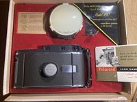 Polaroid Land Camera Model 150 and accessories in presentation box