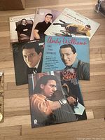 Photo of various vinyl records including Andy Williams, Lamont Kenno, and others, showing cover art and condition.