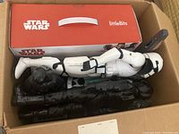 Star Wars LittleBits kit box with large Stormtrooper and Darth Vader figures inside a cardboard box