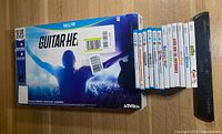Boxed Wii U Guitar Hero Live game with six Wii U games, six Wii games and a wireless Ultra Sensor Bar