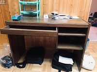 Front view showing dark wood desk with one drawer open on left and two shelves on right
