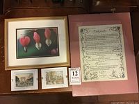 Overall view of the four framed art pieces including the bleeding heart flower photograph, the Teacher's Prayer framed print, and two small Paris art pieces