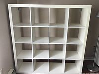 Front view of the white IKEA shelving unit showing 16 square compartments divided evenly in a 4x4 grid.