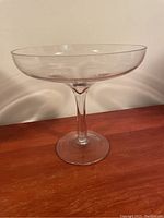 Image showing the large clear glass display piece with round base and wide shallow bowl.