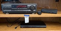 Technics stereo receiver SA-EX320, remote control and Nils Audio speaker amplifier SPS-4 visible together with Toshiba DVD player SK-D1000 below on shelf.