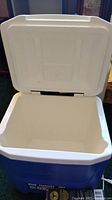 Open blue and white Igloo cooler showing interior and hinged lid.