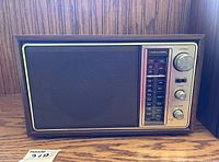 Front view of the MCM Realistic radio showing tuner dial, knobs, and speaker grille.