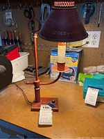 Full view of the vintage Underwriters Laboratories metal desk lamp showing the lamp shade, adjustable arm, base, and labeled with lot number.