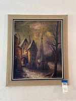 Full view of the framed signed canvas painting showing the entire artwork and frame hanging on a white wall.