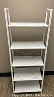 Full view of 5-tier ladder shelf showing white faux marble MDF shelves and metal frame.