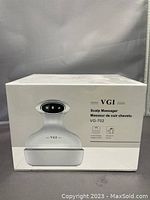 Box of VGI VG-702 scalp massager showing brand and model information.