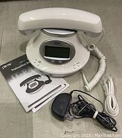 White jWIN JT-P430WHT vintage design telephone with corded handset, coiled cord, instruction manual, AC adapter, and telephone line cord.