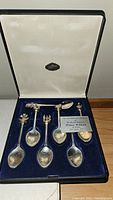 Collector spoons in presentation box with card commemorating birth of Prince William