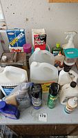 Top view showing various bottles and containers: adhesives, cleaners, bug sprays, and other supplies.