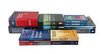 Front and side view of the stacked lot showing varied mechanical engineering books and handbooks of multiple publishers.