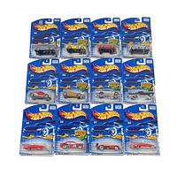Lot of 14 Hot Wheels cars in original blue blister pack packaging arranged in three rows showing variety of models and colors.
