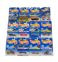 Top view of 12 Hot Wheels cars in blue-backed blister card packages with visible Hot Wheels logos and models.