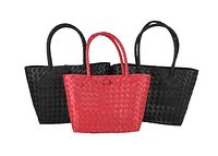 Front view of three woven handbags: two black and one red, showing handles and basket-weave texture.