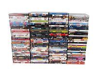 Stacked DVDs in multiple columns showing a large variety of movie titles.