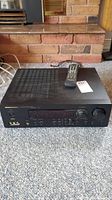Front three-quarter view of Marantz SR4000 receiver on carpeted floor with remote on top.