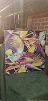 Square canvas featuring bright, colorful fish with abstract geometric and leaf pattern background