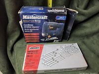 Photo showing closed boxes of Mastercraft 18V cordless orbital jigsaw and Jobmate wrench set side by side.