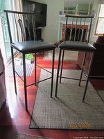 Two Amisco metal counter stools side by side showing the overall height and structure.