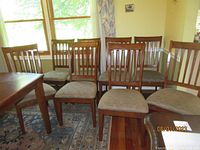 Eight chairs lined up in dining room against wall