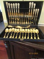 Full set of 39 gold plated flatware pieces in original black box, arranged in rows