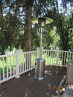 Full view of one Hampton Bay outdoor propane heater on deck, showing vertical structure, base, and top heat reflector.
