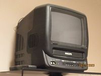 Side and front view of compact Philips CRT TV with integrated VHS player.