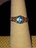 Front view of ring on display stand showing center stone and band