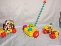 All three vintage Fisher-Price toys displayed together on white background.